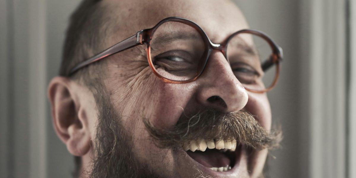 A person experiencing genuine joy and laughter, reflecting the comedic power of face swap videos.
