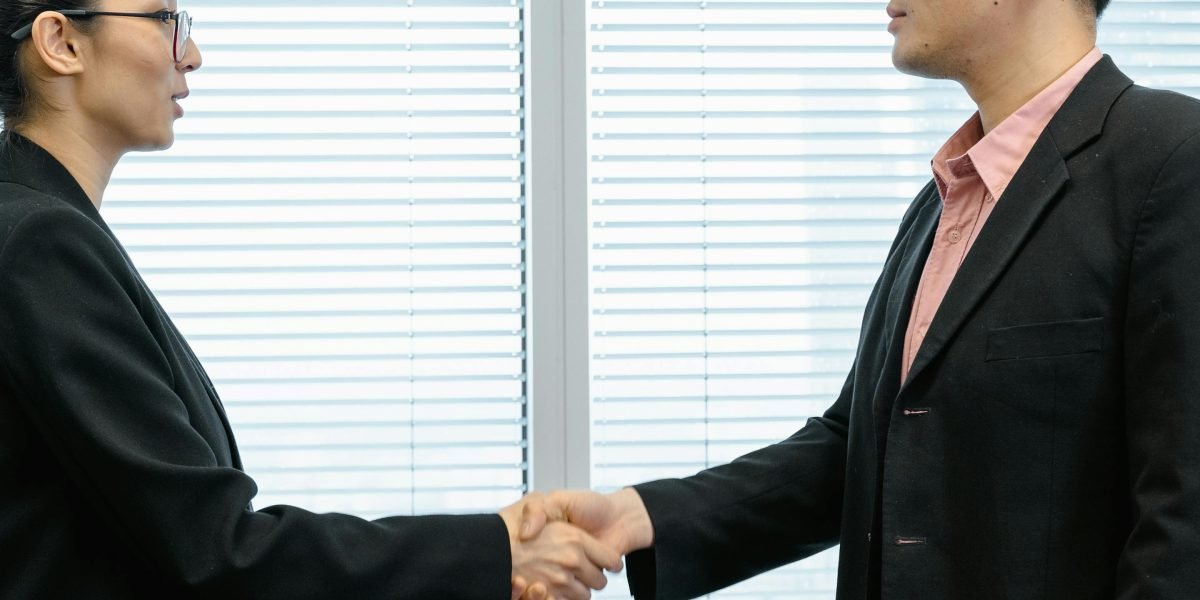 Two professionals engaging in a negotiation, symbolizing the need to haggle for better internet deals.