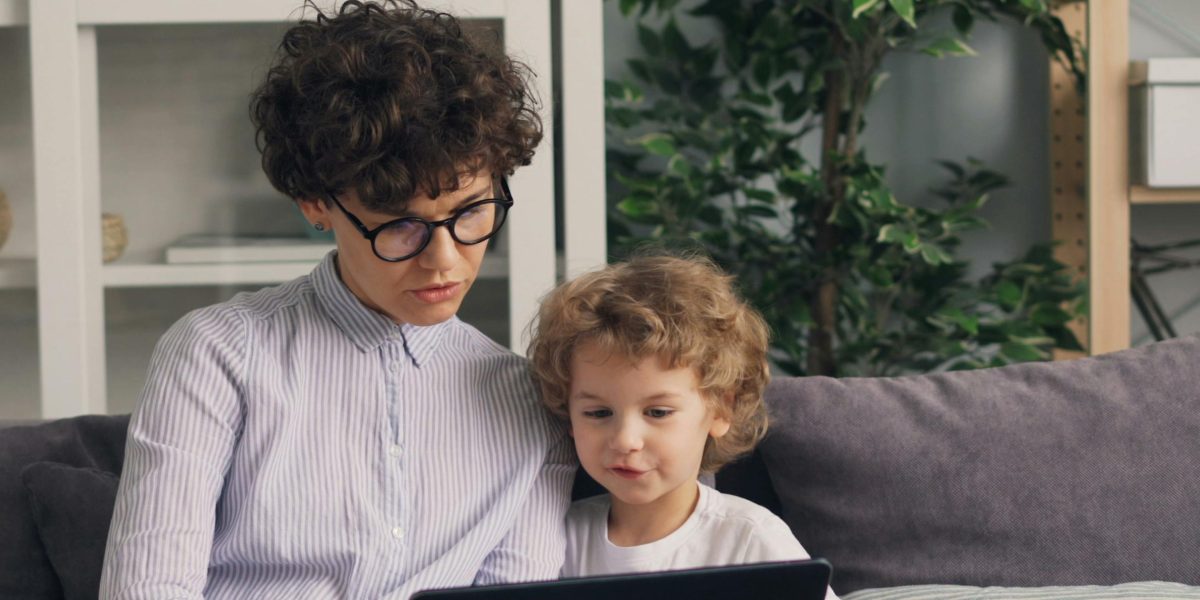 A parent and child sharing a moment of co-viewing, turning screen time into a bonding experience.