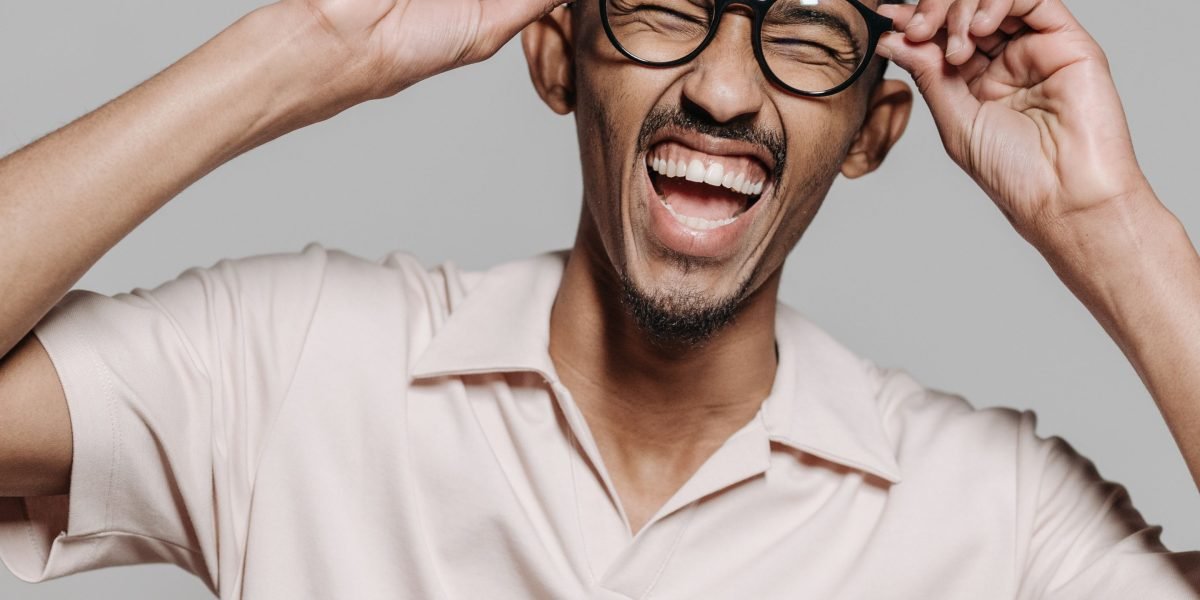 A person laughing genuinely, symbolizing the therapeutic benefits of humor discussed in the article.