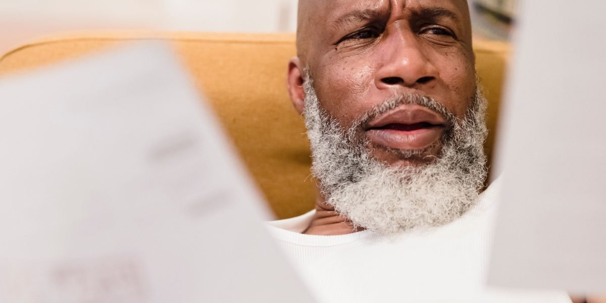 A person looking puzzled while reviewing many documents, representing the complexity of router admin pages.