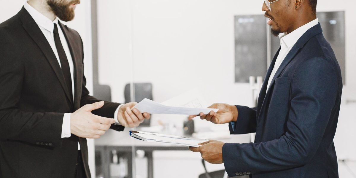Two individuals engage in a serious discussion, symbolizing agreement on legal and ethical matters.