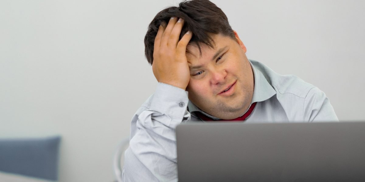 A person shows visible frustration as their internet connection buffers, highlighting common home network issues.