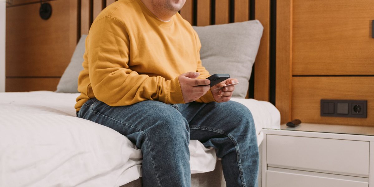 A person thoughtfully considers the best placement for a home device, aiming for optimal function.