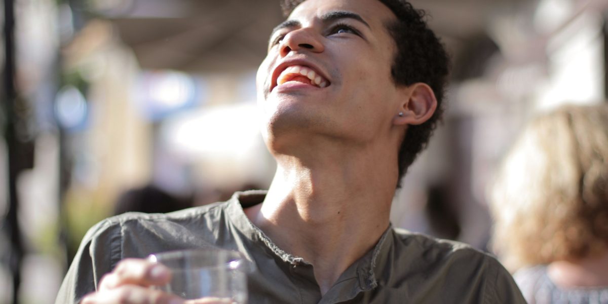 A person enjoying a moment of genuine laughter, highlighting the stress-relief benefits.